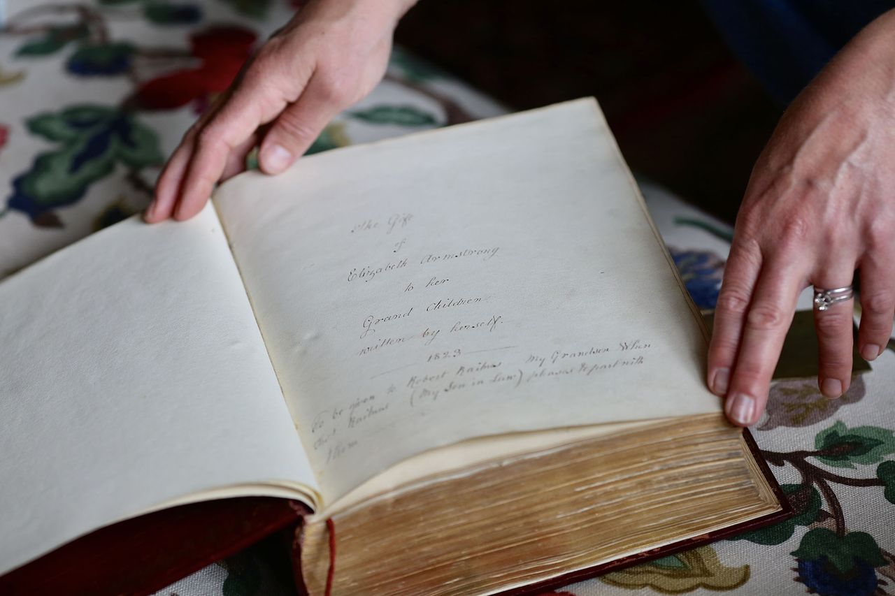Sally Raikes and the hand-written bible at Treberfydd House in Brecon