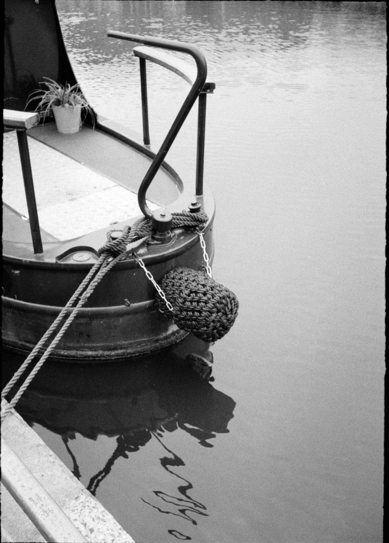 Close up of the front of a canal boat on water