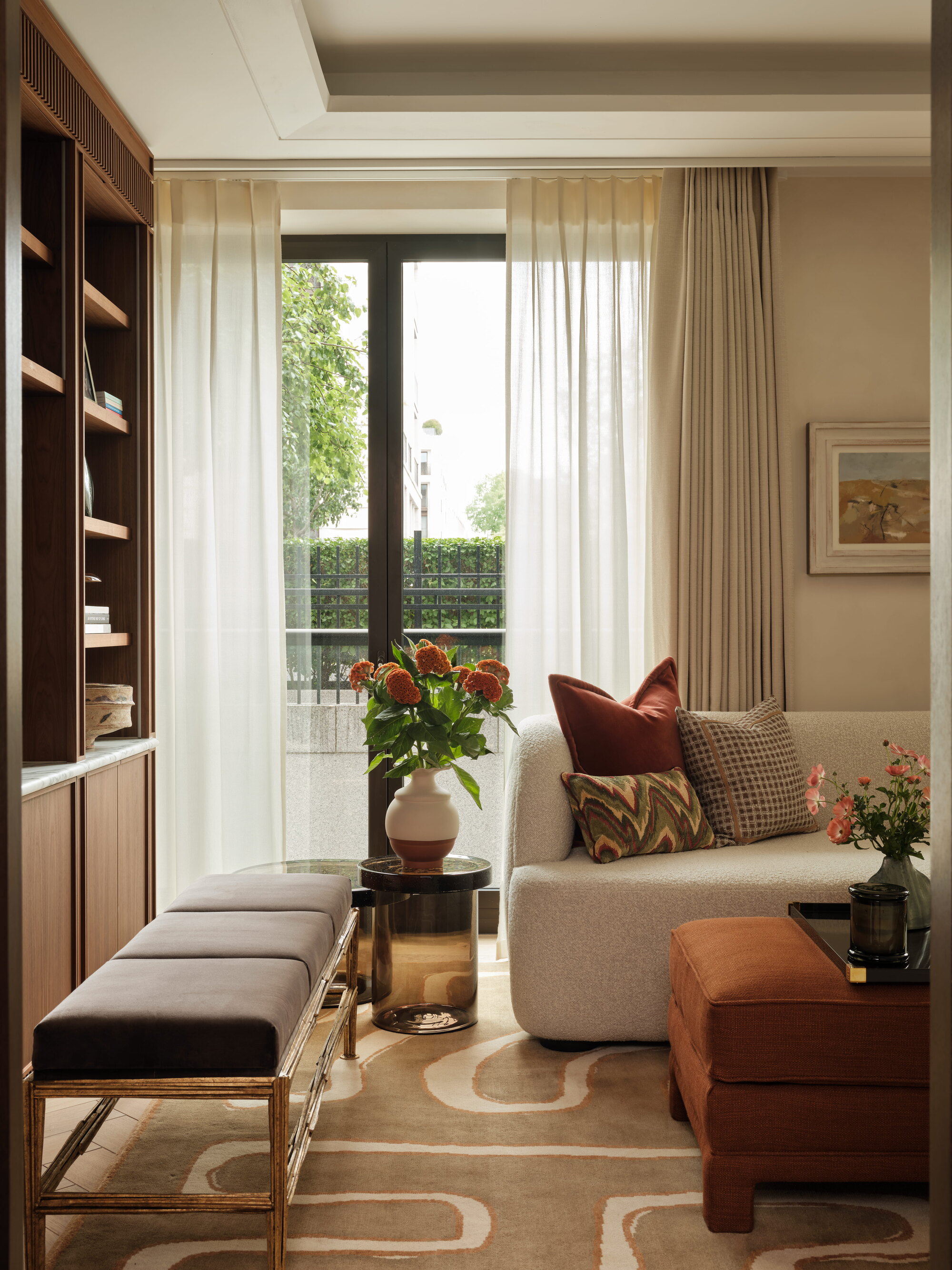 a warm toned living room with layered curtains
