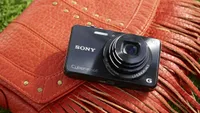 The Sony WX220 resting on a leather handbag