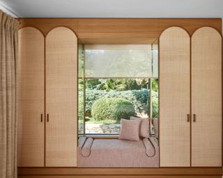 window seat incorporated into joinery with mirrored panels