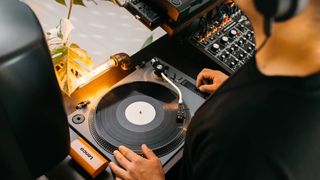 Lifestyle stock of a DJ playing using the Lenco L-3810