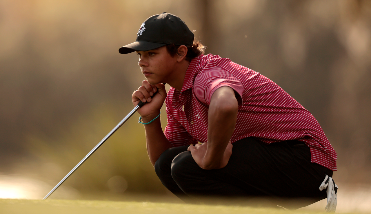 Charlie Woods lines up a putt