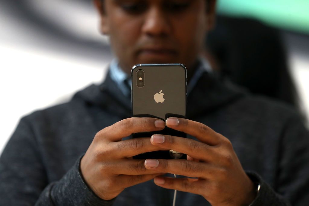 A man looks at the iPhone X. 