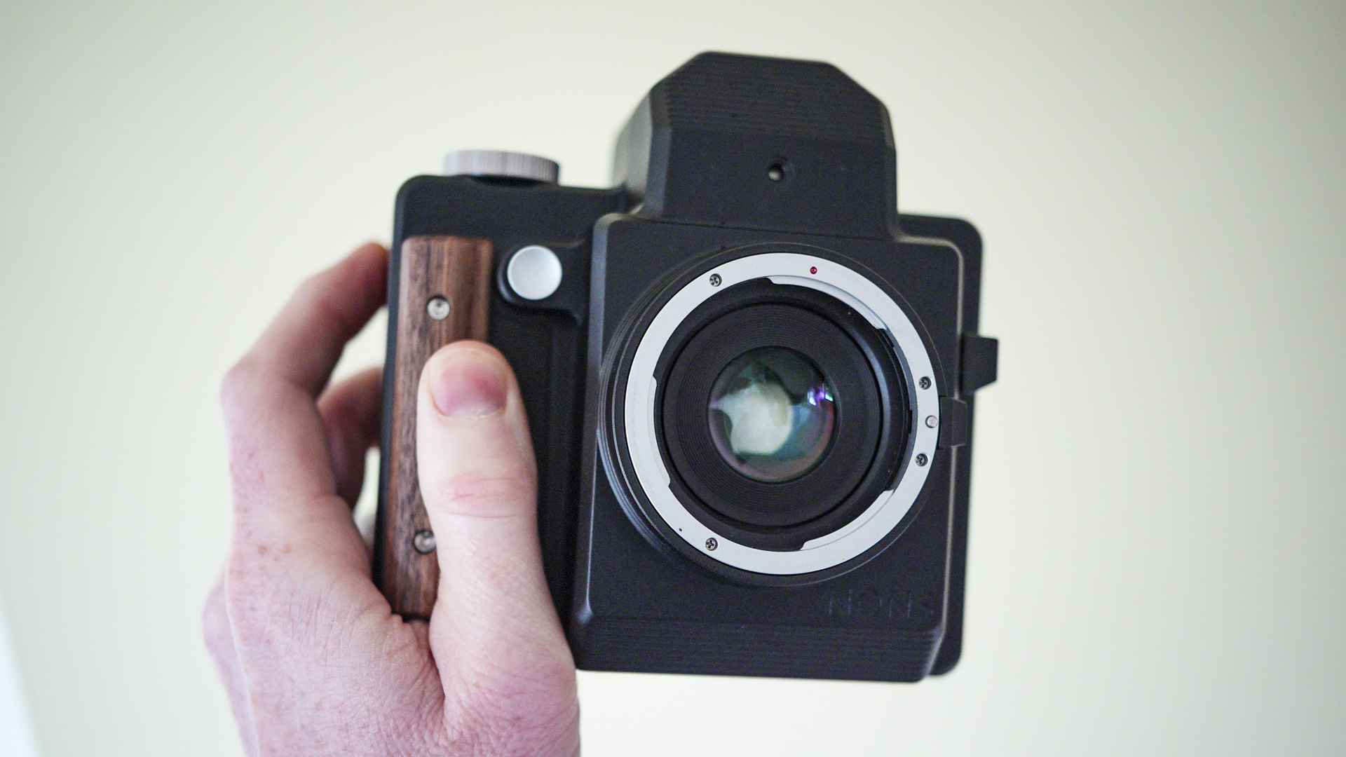 Nons SL660 instant camera in the hand, no lens attached
