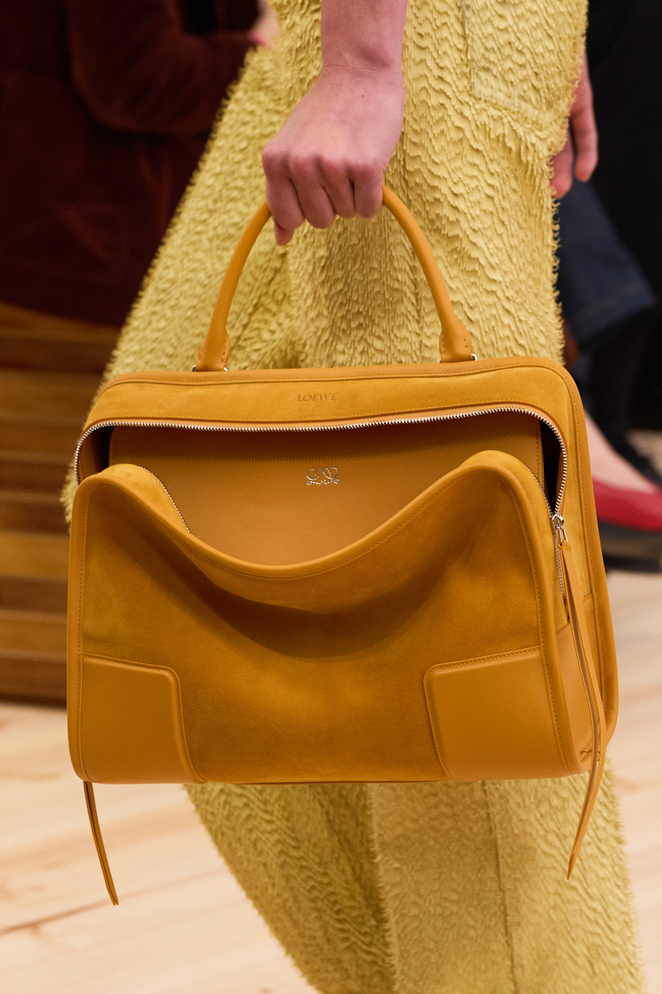 a mustard yellow one-sided handbag trend at Loewe Spring 2026
