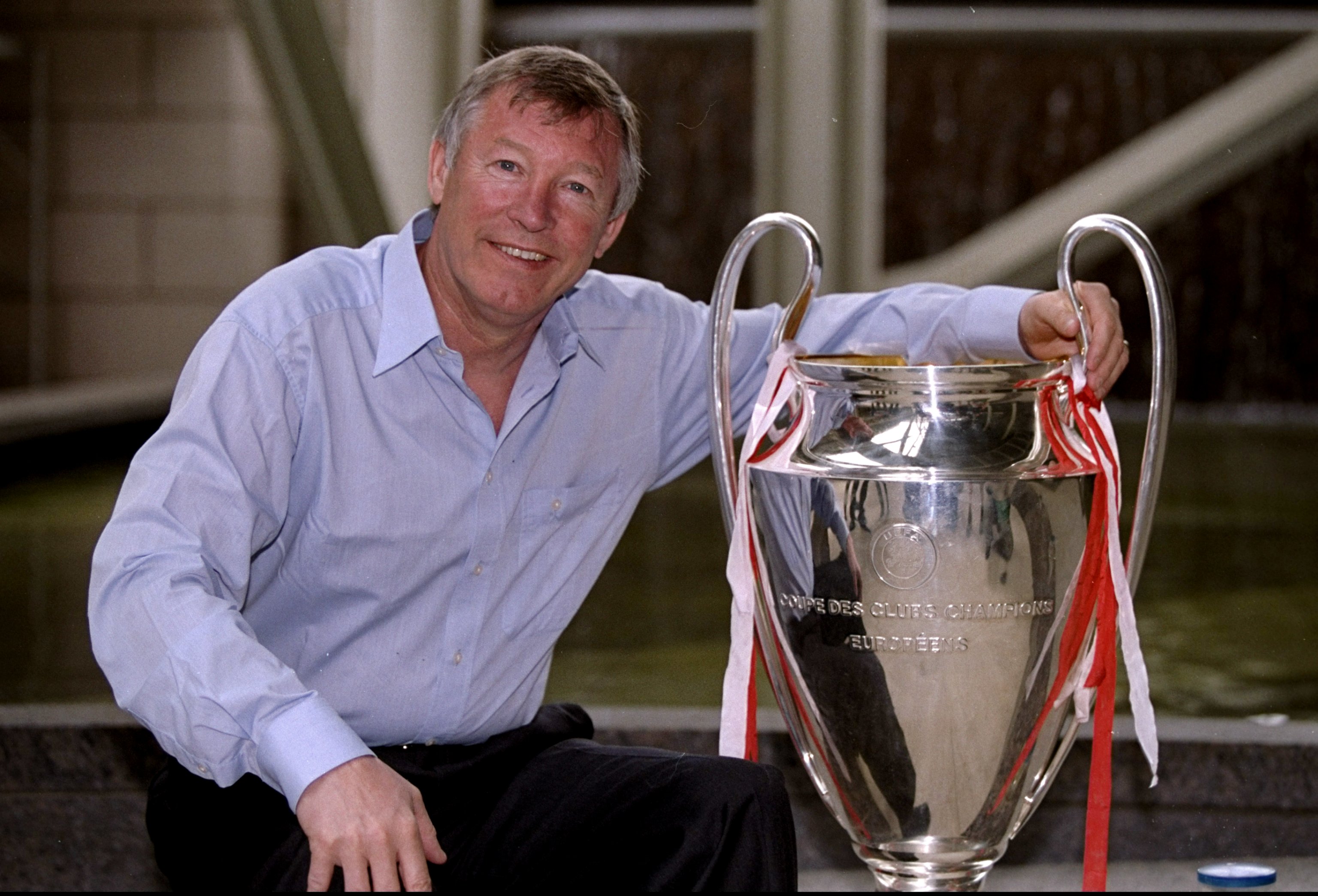 Sir Alex Ferguson poses with the Champions League trophy after Manchester United's win over Bayern Munich in the 1999 final.