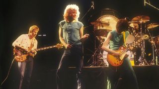 (from left) Led Zeppelin's John Paul Jones, Robert Plant, and Jimmy Page perform onstage
