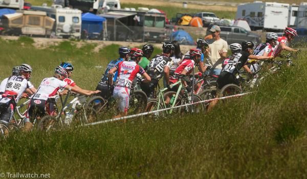 Racers including Cal Giant's Nick Weighall are forced off their bikes on the first climb
