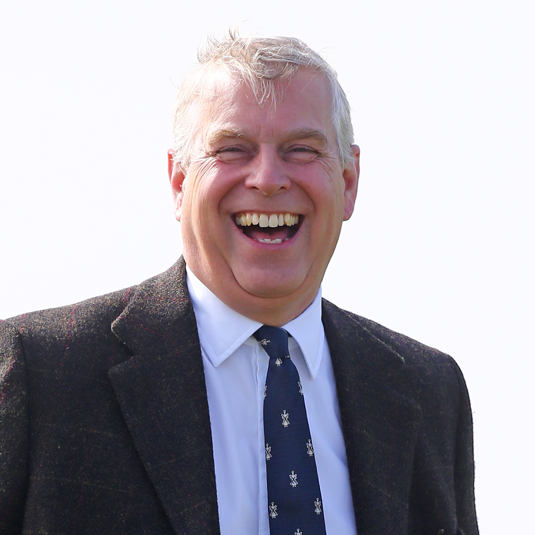 Ex-Prince Andrew laughs while wearing a suit and tie
