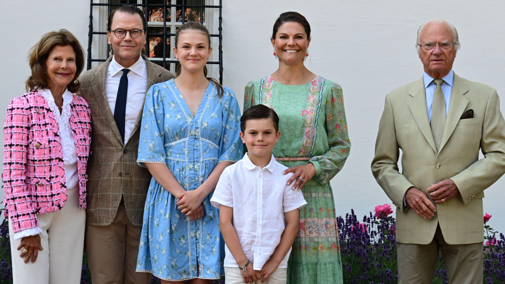Prince Daniel, Princess Estelle, Prince Oscar and Crown Princess Victoria posing with King Carl Gustaf and Queen Silvia in suits and dresses on Victoria's birthday