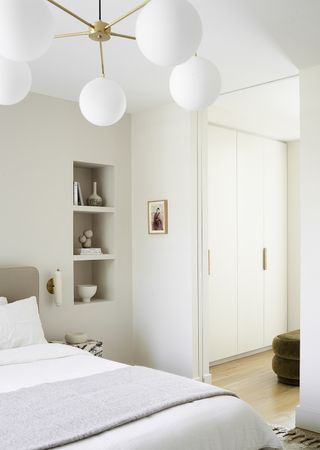 white bedroom with big white pendant light