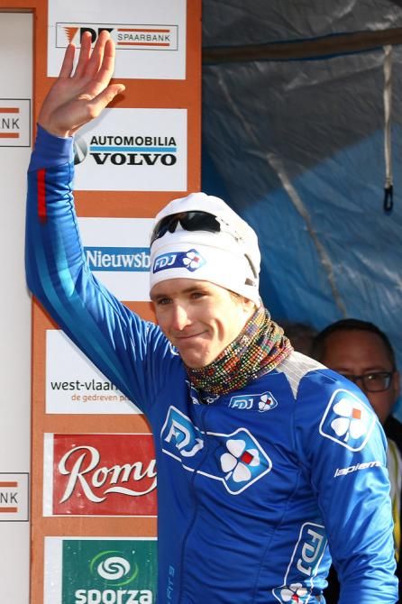 Arnaud Demare (FDJ) steps onto the podium to receive the leader's jersey