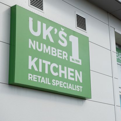 Green Wren sign on grey building