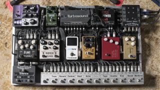 A neat pedalboard with a pedal switcher and lots of guitar pedals