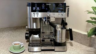 Ninja Luxe Caf&eacute; coffee maker on klitchen counter with potted plant and espresso cup