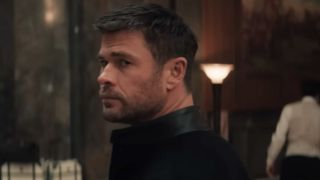 Chris Hemsworth looking over his left shoulder in Crime 101.