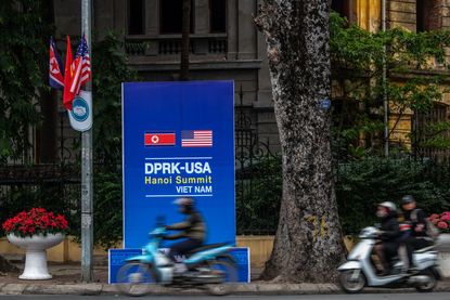  Scooters pass a banner announcing the forthcoming summit between North Korea's leader Kim Jong-un and U.S President Donald Trump, on February 24, 2019 in Hanoi, Vietnam. 