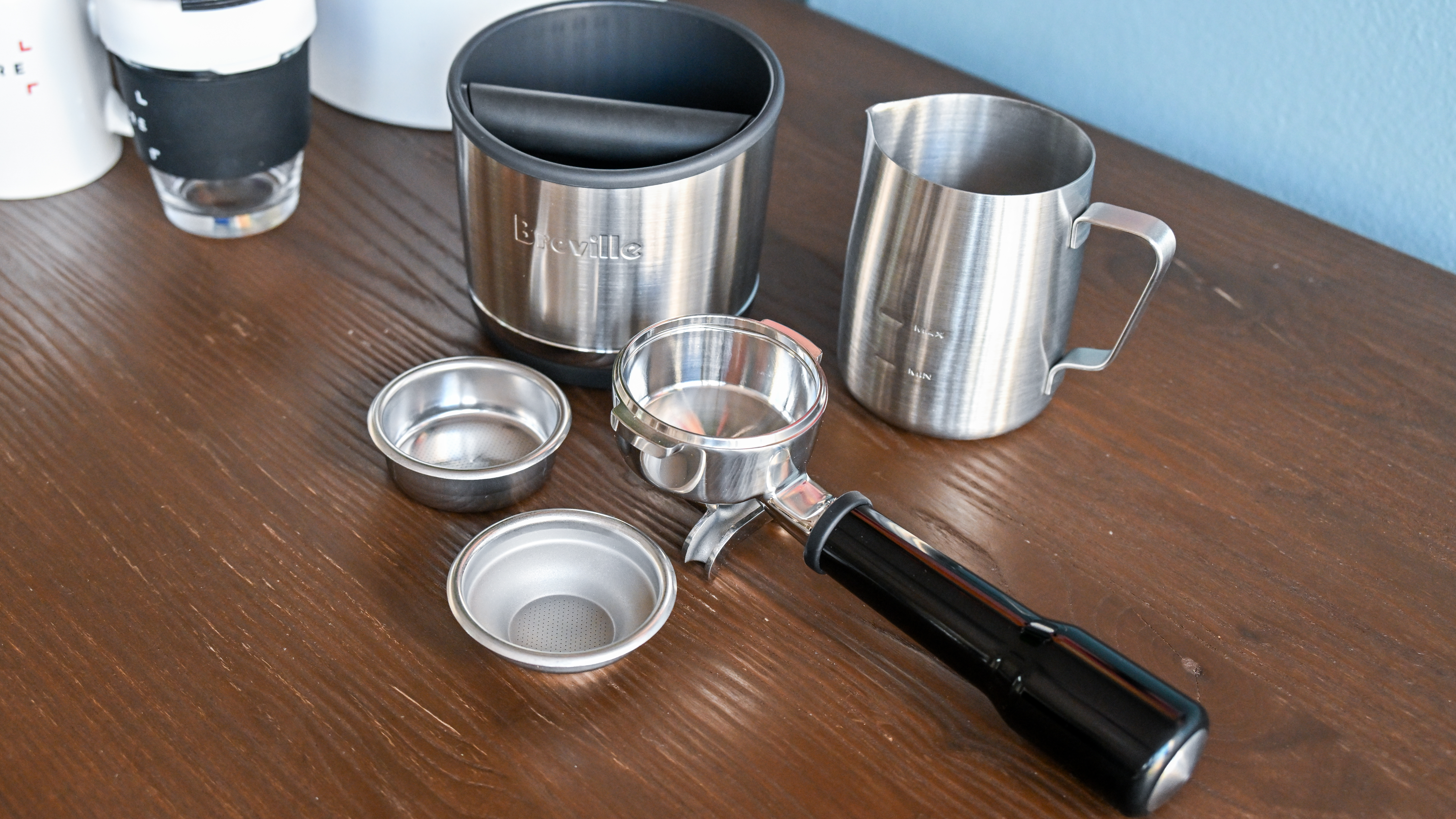 The portafilter, single- and double-shot baskets, grinds bin and milk jug that are included with the Breville Oracle Jet.