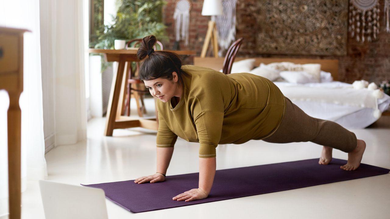 Woman holding a plank in a yoga class