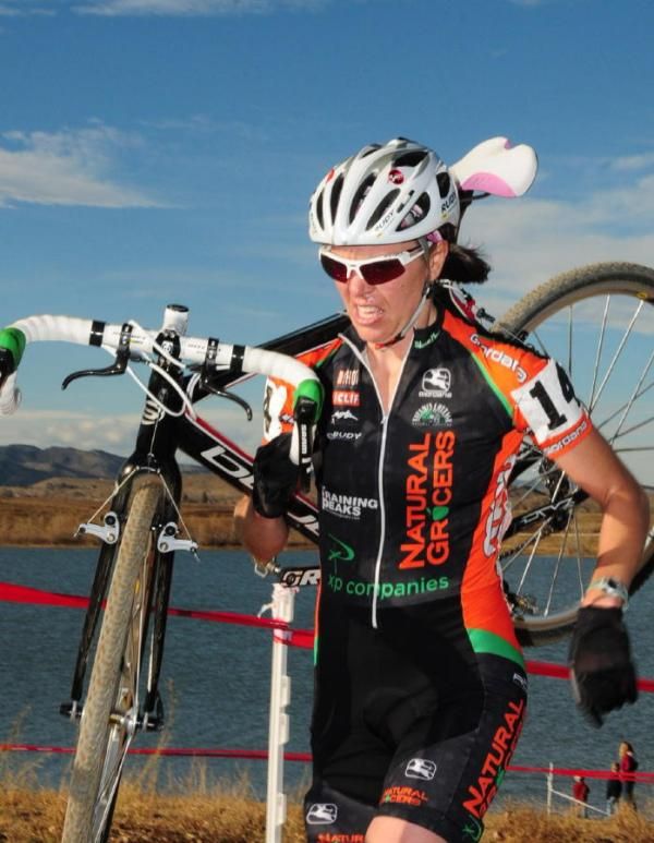 Lisa Matlock Strong (Natural Grocers) running with her bike.