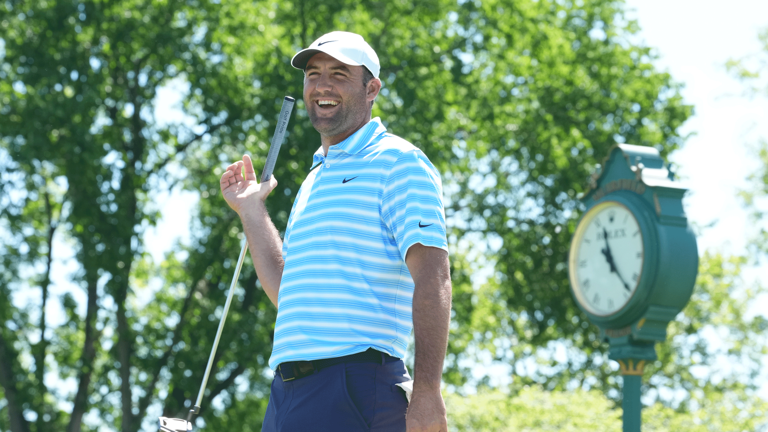 Scottie Scheffler laughs while twirling his putter around during a practice round at the Memorial Tournament in 2026