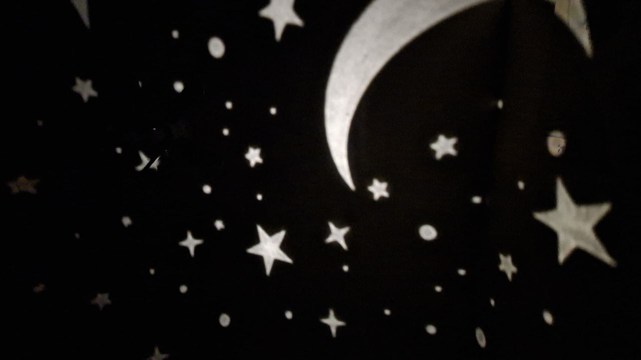 Projections of the moon and stars from a star projector.