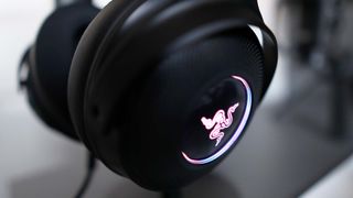 Razer Kraken V3 Hypersense pictured on desk hanging from a stand