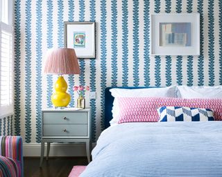 blue and pink bedroom with yellow lamp