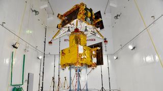 gold and black Indian moon lander, rover and its ferry spacecraft in a clean room