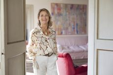 Portrait of an elegantly dressed mature woman in her beautiful apartment in Rome.