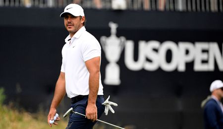 Brooks Koepka in front of a US Open board