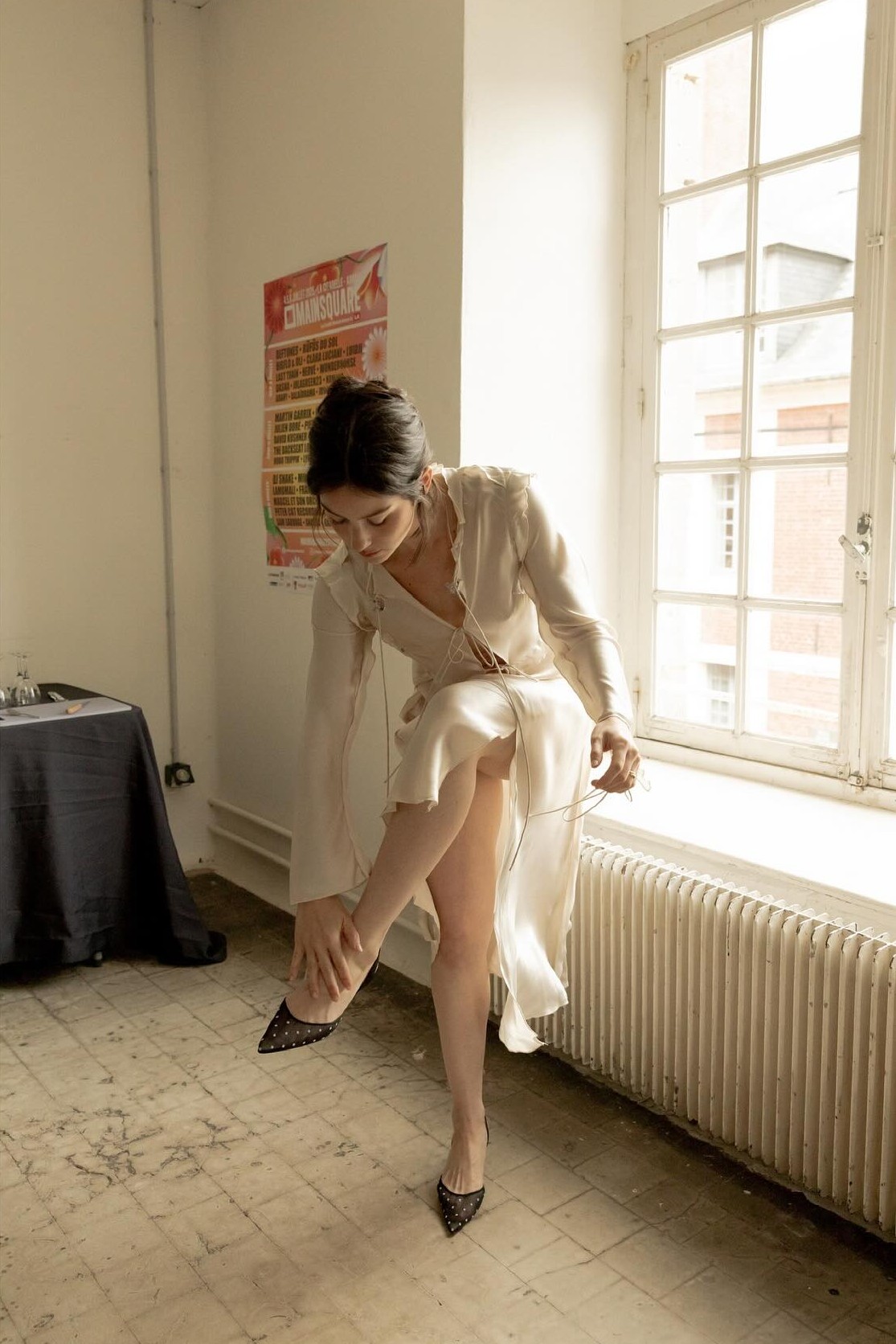 An image of @gracieabrams wearing the Carolyne 50 polka-dot flocked mesh and satin slingback pumps.