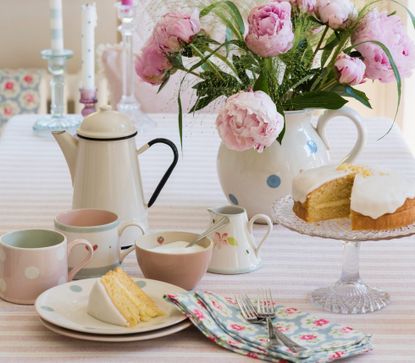 J7AGDY Sponge cake, enamel teapot and pink peonies on striped table cloth from Susie Watson Designs