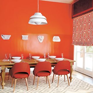 dining room with charlottes locks paint and dining chairs in orange