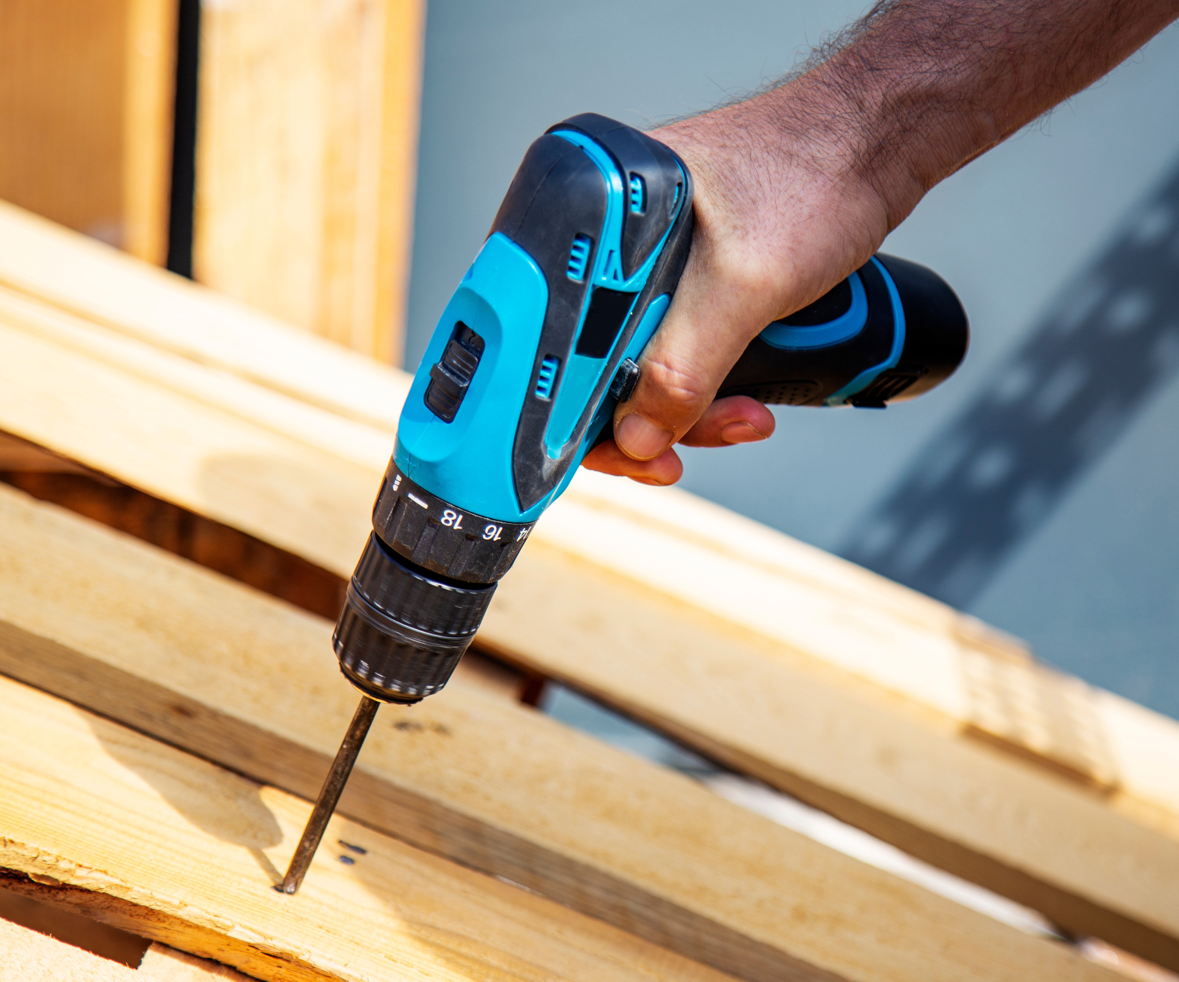 cordless drill being used on wooden planks