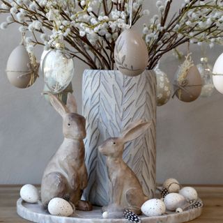 pot with easter egg and rabbit statue