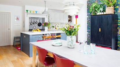 blue and grey kitchen with floral wallpaper