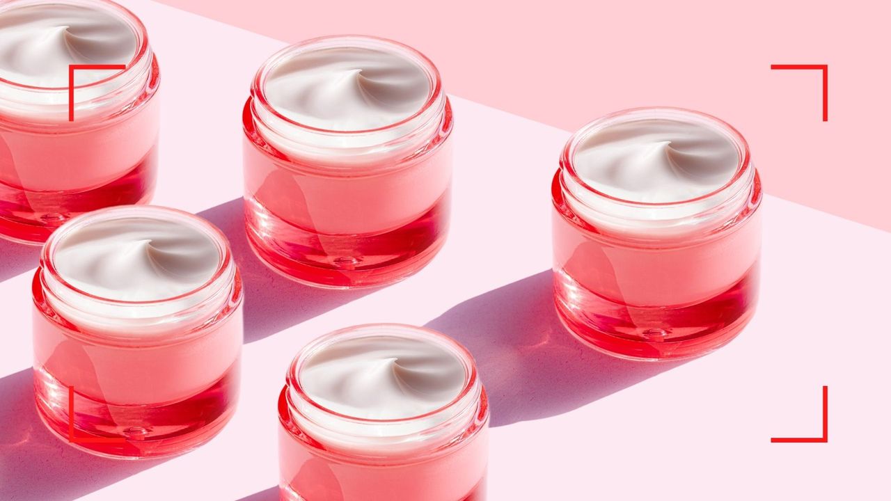 pots of eye cream with a pink and red colored background