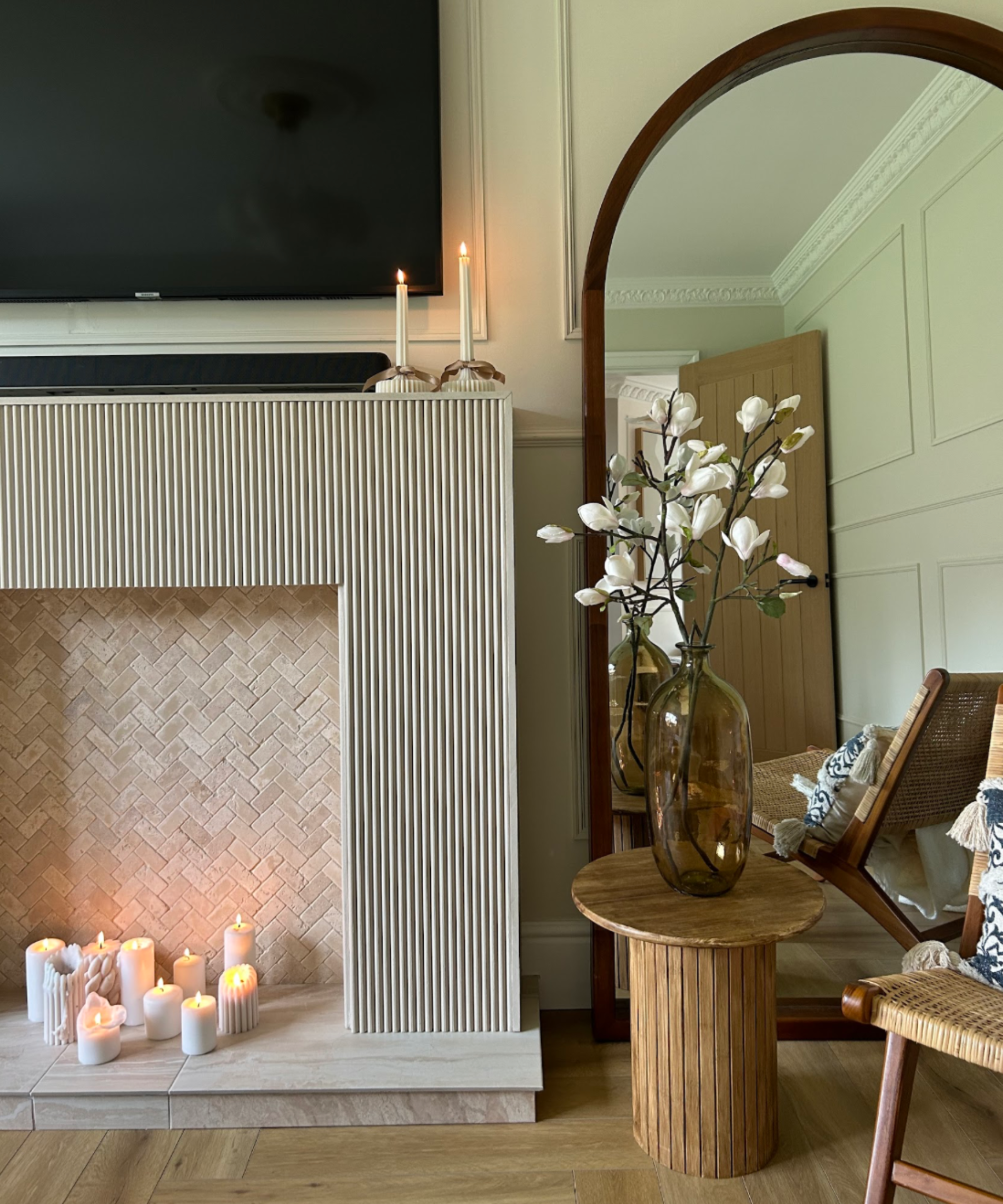 Living room with a panelled fireplace and candles inside