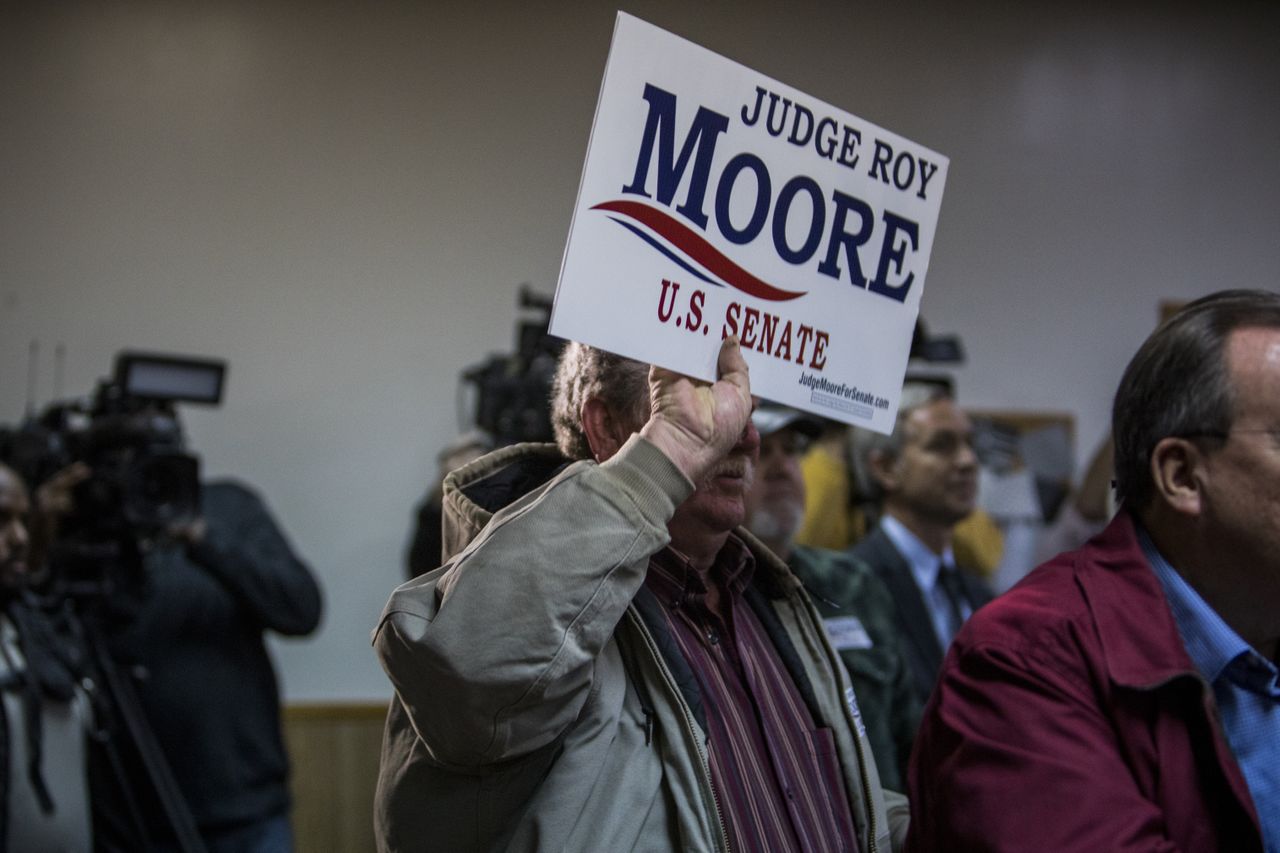 A Roy Moore supporter with a sign