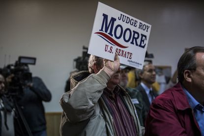 A Roy Moore supporter with a sign