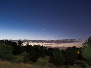 Skywatcher Cory Poole sent this photo of Jupiter and Venus seen from Redding, CA, on July 5, 2012. Poole writes: "You can see Venus passing through the Hyades open star cluster with Jupiter and the Pleiades above that. The foreground was illuminated by a flashlight and the exposure time was 15 seconds."