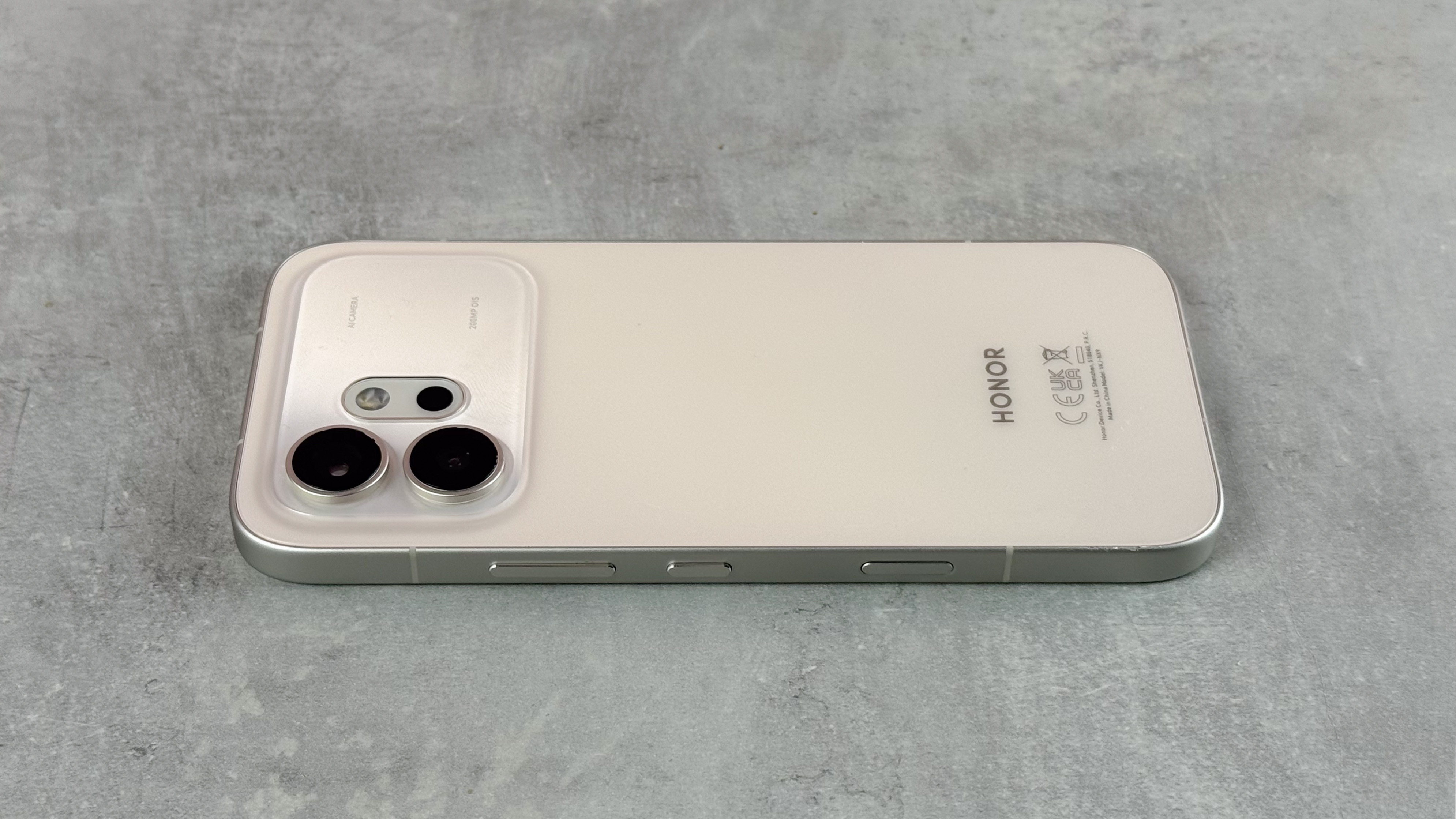 The Honor 600 laying screen down on a gray tabletop.