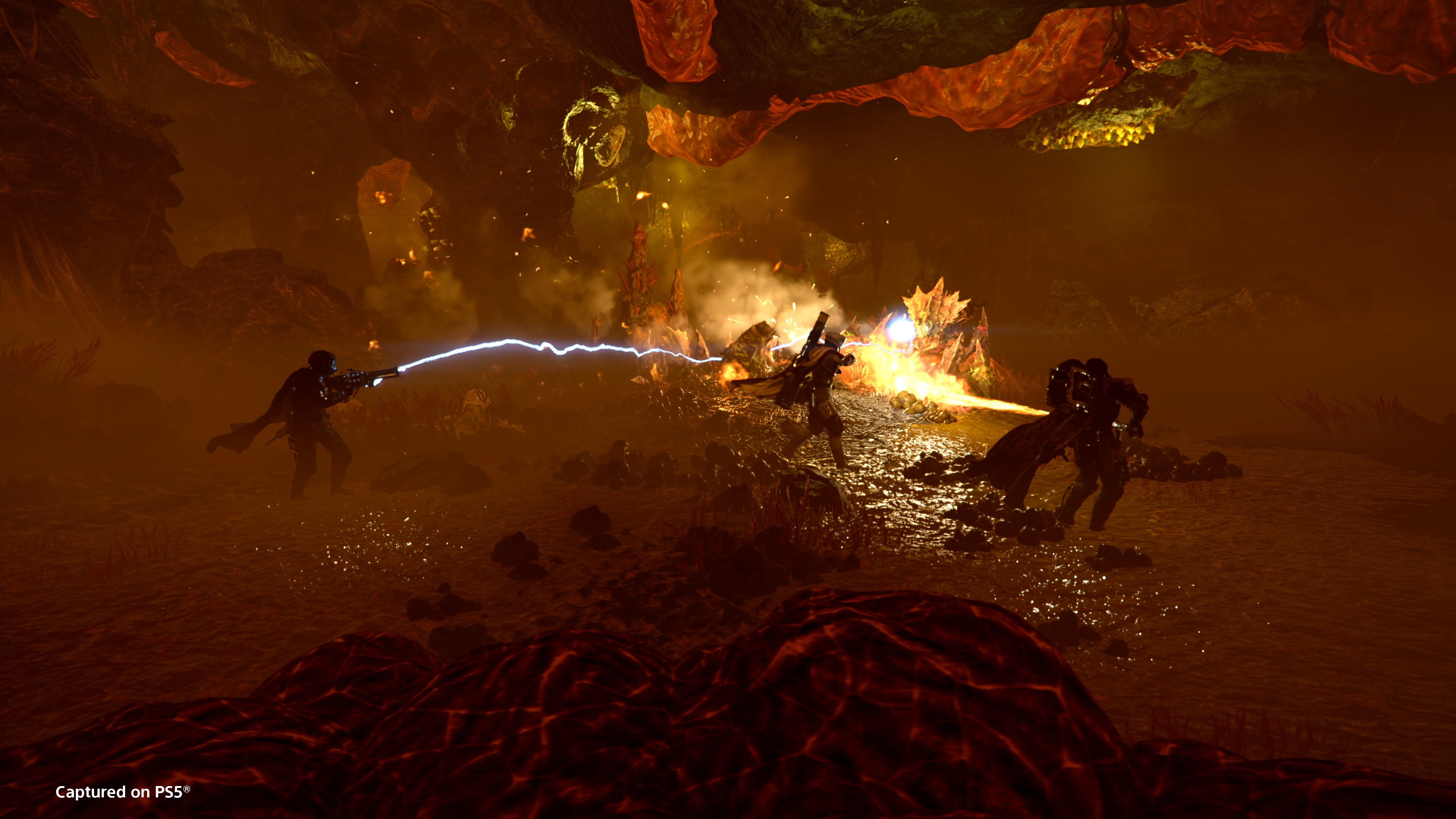 A squad of Helldivers in a Terminid hive in Helldivers 2