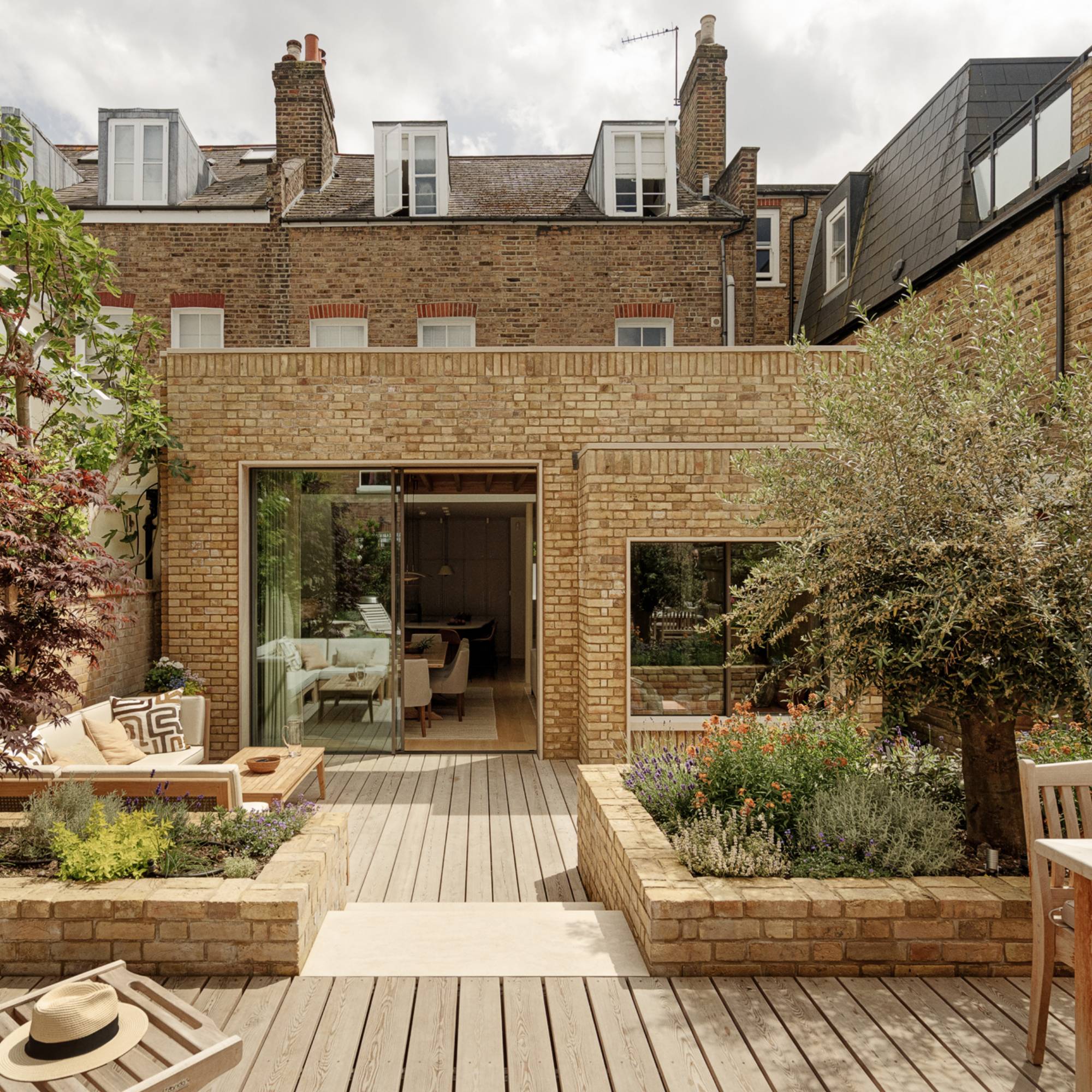 pale brick extension to London house with sliding doors and large decked garden