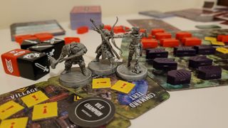 Miniatures of a dwarf, wizard, and archer stand on board tiles amidst tokens and dice from Dragonlance: Warriors of Krynn