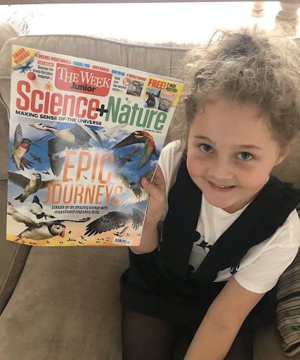Young girl holding Science + Nature magazine