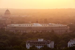 India's parliament building at sunset