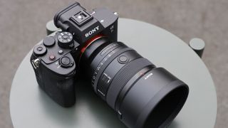 Sony FE 50mm f/1.4 GM lens on a small table